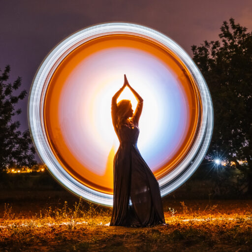 Female silhouette in glowing circle in nature